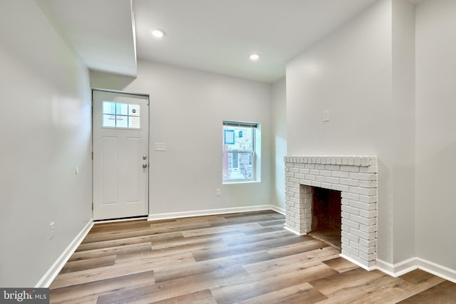1341 Sargeant St, Baltimore, MD 21223 - foyer entrance featuring wood finished floors, baseboards, recessed lighting, and a fireplace