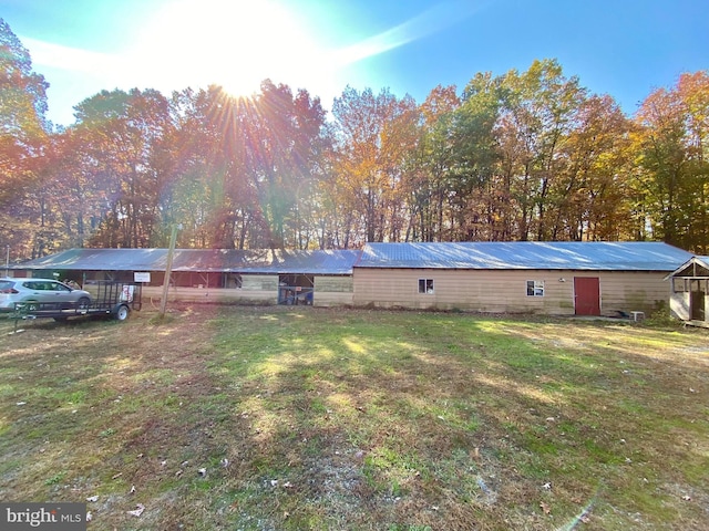 rear view of property with a lawn