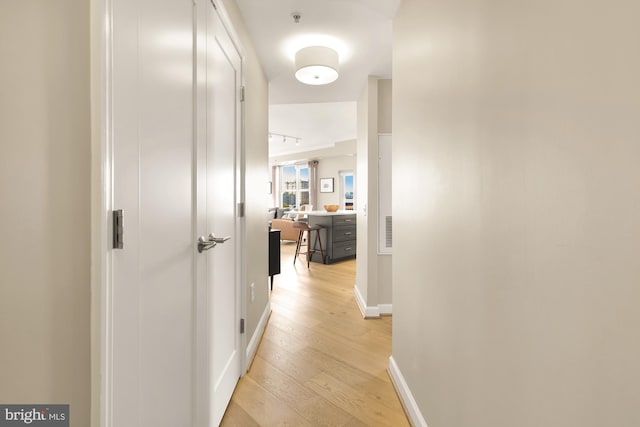 corridor with light hardwood / wood-style flooring