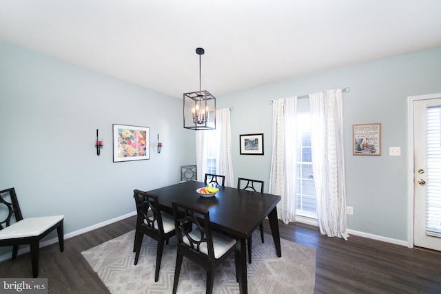 dining space featuring a chandelier and dark wood-type flooring