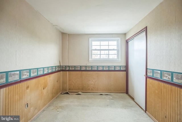 spare room featuring wood walls