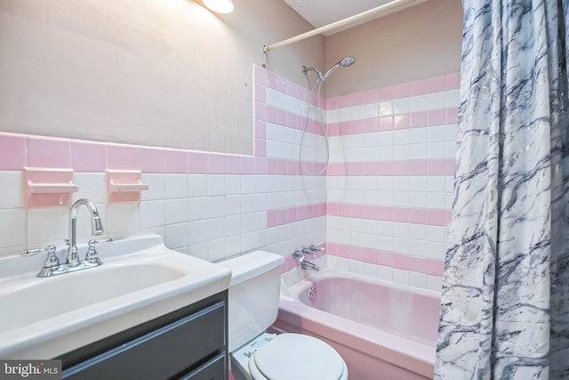 full bathroom with vanity, toilet, shower / bathtub combination with curtain, and tile walls