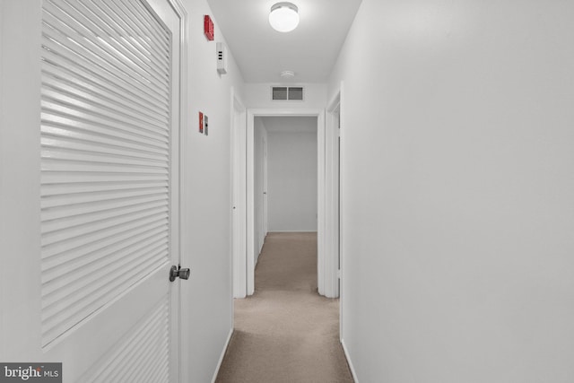 hallway with light colored carpet