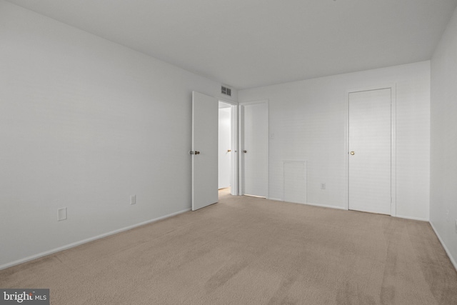 unfurnished bedroom with light colored carpet