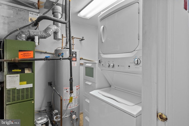 utility room with gas water heater, heating unit, and stacked washer / drying machine