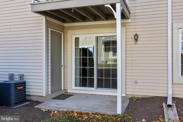 entrance to property with central AC unit and a patio area