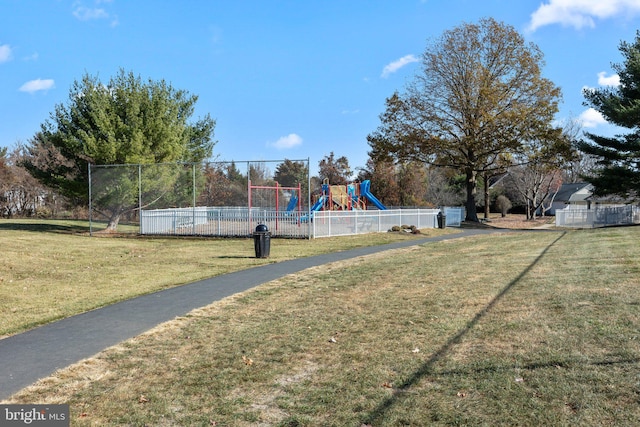 view of home's community with a playground and a yard