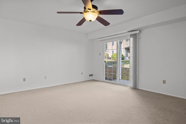 carpeted spare room with ceiling fan