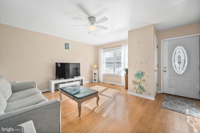 living room with ceiling fan and light hardwood / wood-style flooring