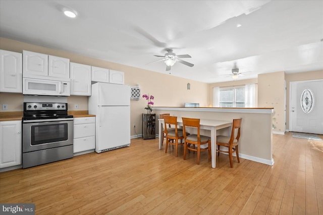 kitchen featuring light hardwood / wood-style floors, white appliances, ceiling fan, and white cabinets