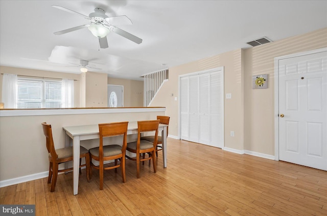 dining room with light wood-type flooring and ceiling fan