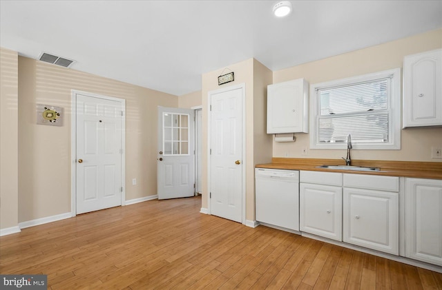 kitchen with white cabinets, white dishwasher, and wood counters