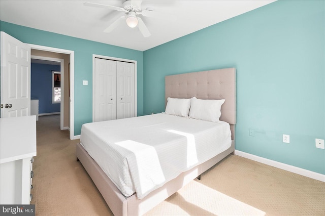 carpeted bedroom with ceiling fan and a closet