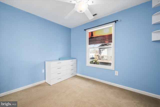 unfurnished bedroom with ceiling fan and light carpet