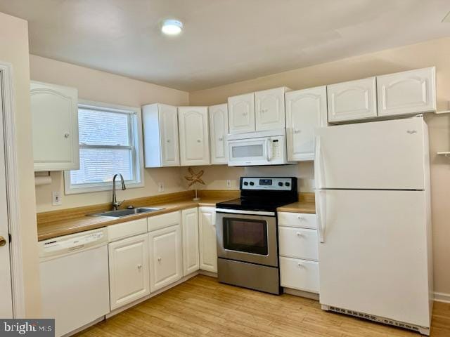 kitchen featuring white cabinetry, white appliances, sink, and light hardwood / wood-style flooring