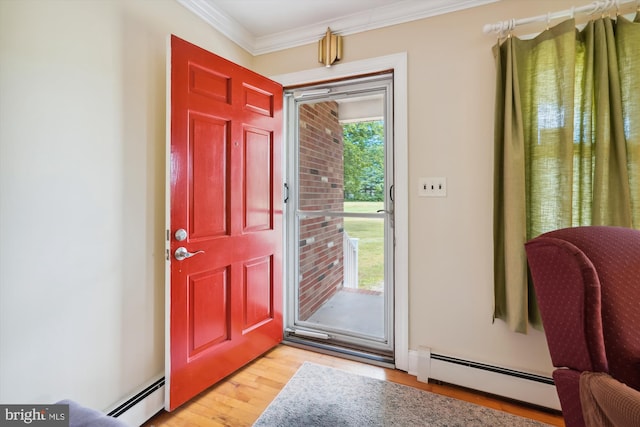 entrance foyer featuring light hardwood / wood-style floors, crown molding, and a baseboard heating unit