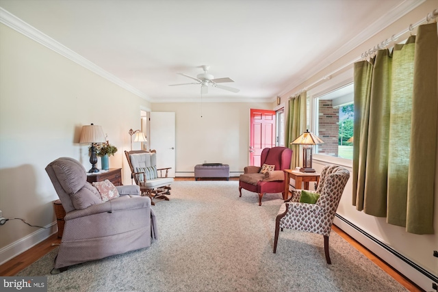 living room featuring a baseboard heating unit, wood-type flooring, ceiling fan, and crown molding