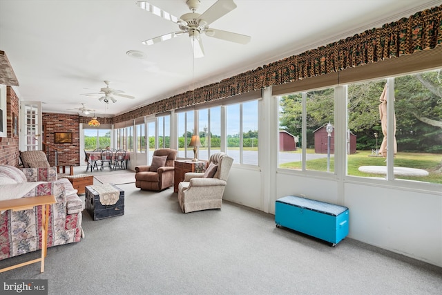 sunroom featuring ceiling fan