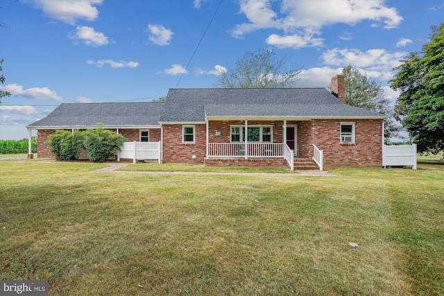 view of front of house with a front yard and covered porch