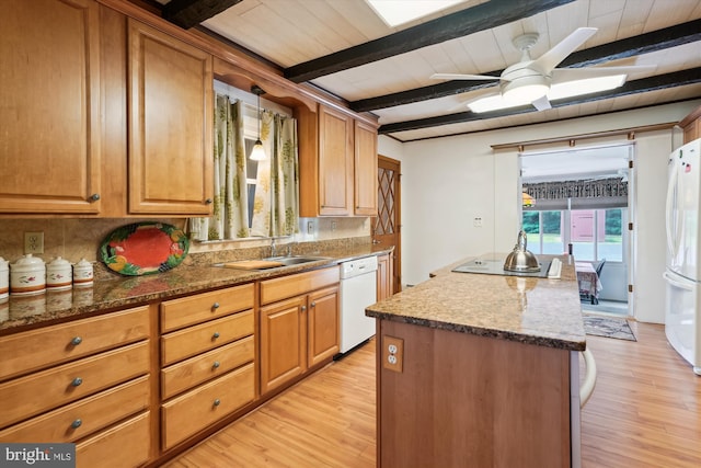 kitchen featuring beam ceiling, sink, white appliances, ceiling fan, and light hardwood / wood-style flooring