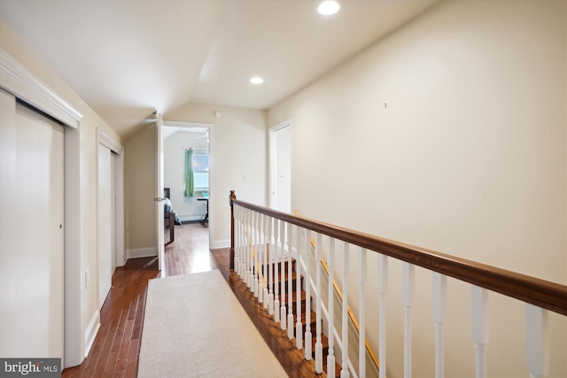 hall with dark hardwood / wood-style floors and lofted ceiling