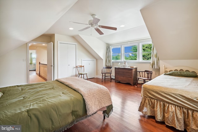 bedroom with hardwood / wood-style floors, ceiling fan, a closet, and lofted ceiling