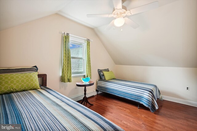 bedroom with ceiling fan, dark hardwood / wood-style floors, a baseboard radiator, and vaulted ceiling