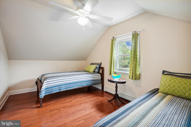 bedroom featuring lofted ceiling, hardwood / wood-style floors, baseboard heating, and ceiling fan