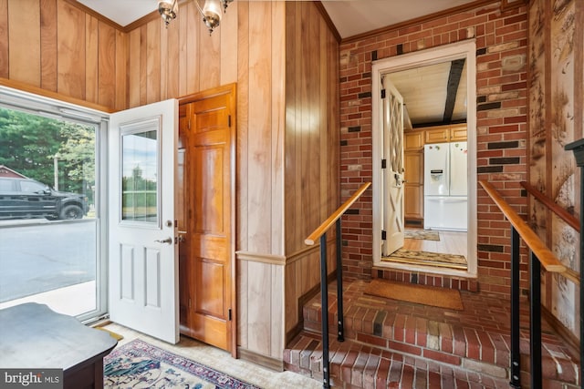 interior space with wood walls and brick wall