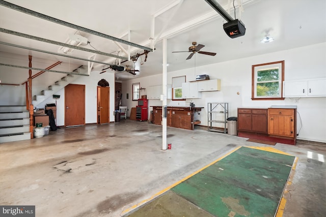 garage with a garage door opener and ceiling fan