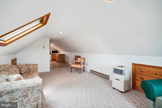 additional living space with a baseboard radiator, light carpet, and vaulted ceiling with skylight