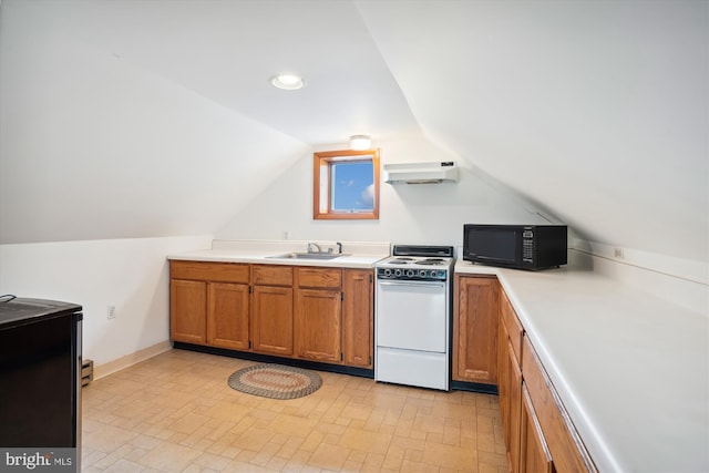 kitchen featuring lofted ceiling, stove, and sink