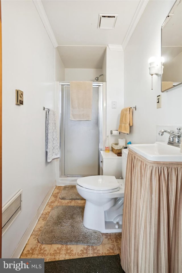 bathroom featuring tile patterned floors, a shower with door, crown molding, vanity, and toilet