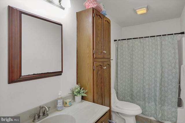 bathroom with tile patterned flooring, vanity, and toilet