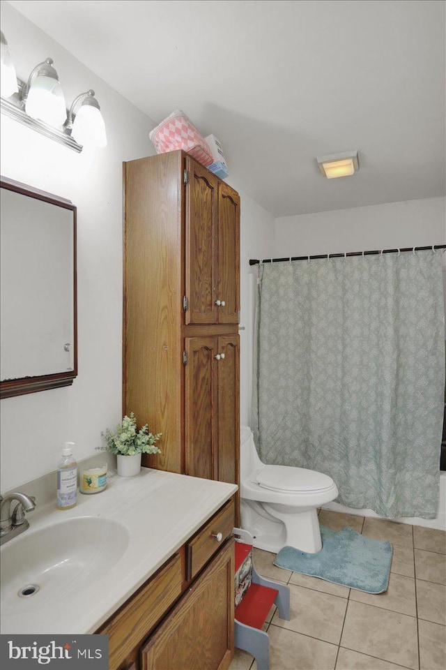 bathroom featuring toilet, vanity, and tile patterned floors