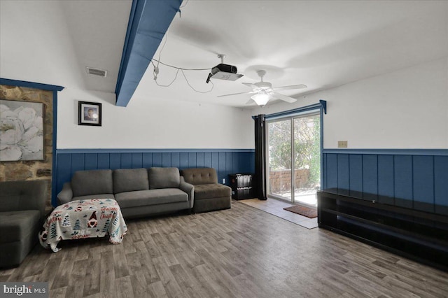 living room featuring ceiling fan and wood-type flooring