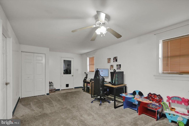 carpeted home office with ceiling fan