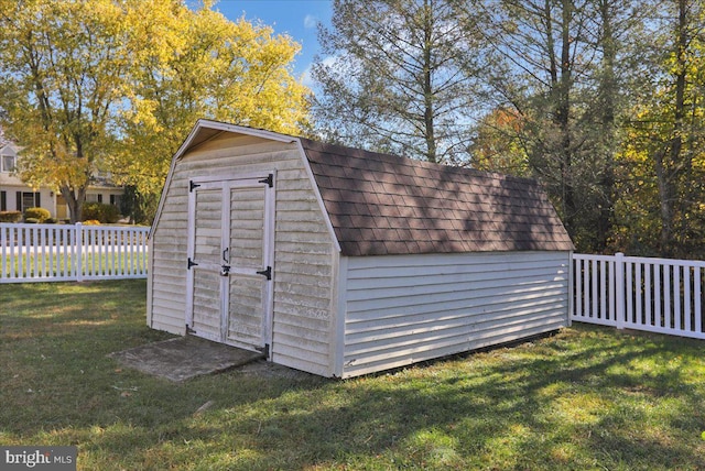 view of outbuilding with a lawn