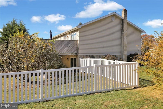 view of home's exterior featuring a yard