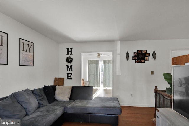 living room with ceiling fan and dark hardwood / wood-style floors