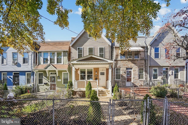 townhome / multi-family property featuring covered porch