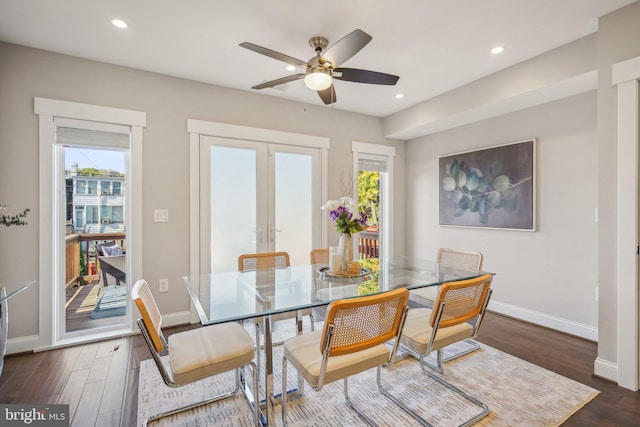 dining room featuring dark wood-type flooring, ceiling fan, and french doors