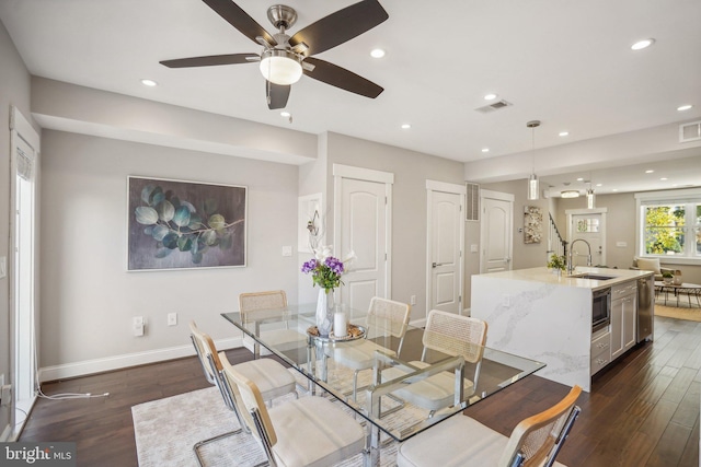 dining room featuring dark hardwood / wood-style flooring, sink, and ceiling fan