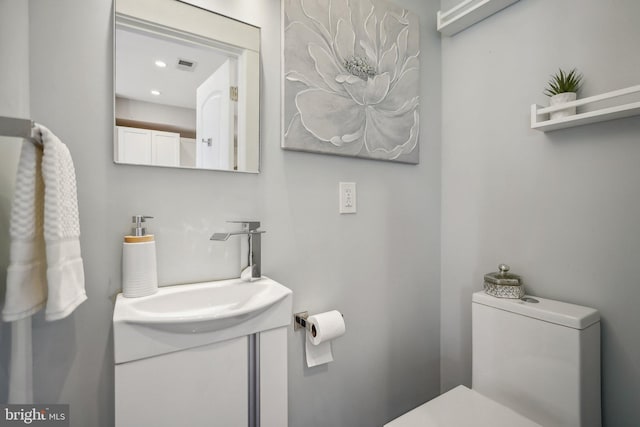 bathroom featuring toilet and vanity