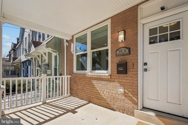 doorway to property featuring covered porch