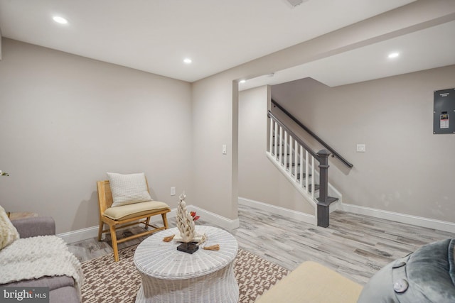 living room featuring electric panel and light wood-type flooring