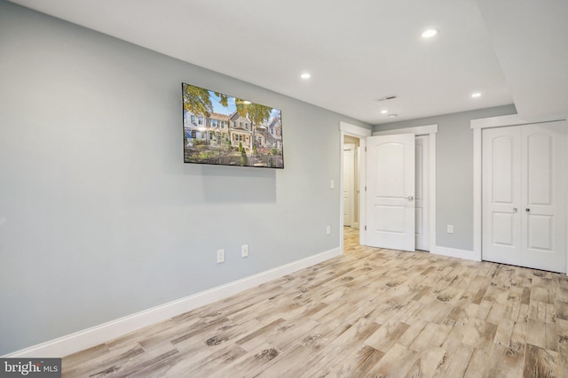 unfurnished bedroom with light wood-type flooring