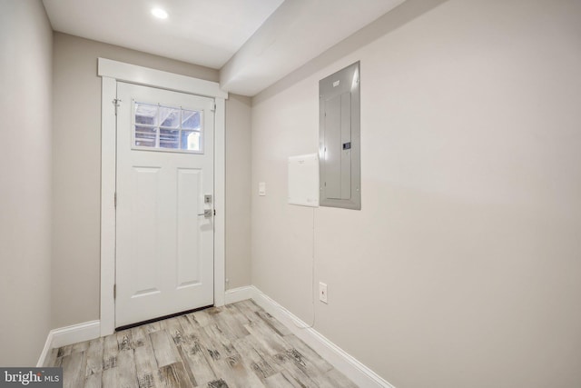 foyer with electric panel and light wood-type flooring