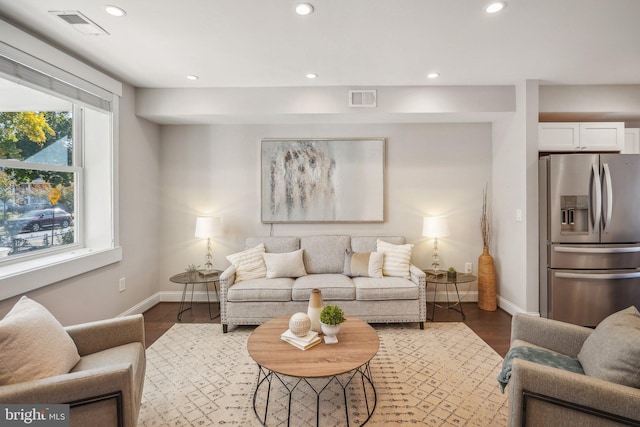 living room with dark hardwood / wood-style flooring