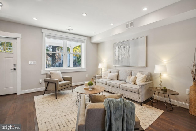 living room with a healthy amount of sunlight and dark hardwood / wood-style floors